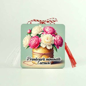 Imagine cu un martisor din lemn personalizat cu flori de bujori roz si albi. Martisorul are scris mesajul Primavara minunata si un nume.